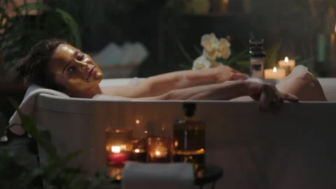 Opulent Bubble Bath with Gold Face Mask Stock Footage 320031480