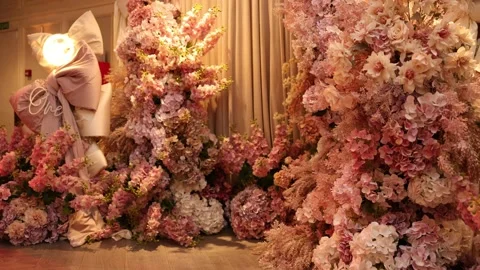 Opulent floral setup featuring warm lighting and pastel tones Stock Footage 327013954