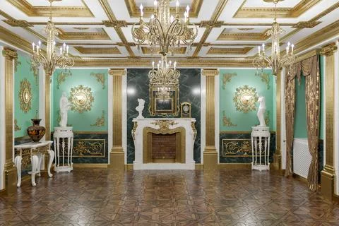 Opulent palace interior featuring a marble fireplace, gilded moldings, classi Stock Photos
