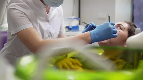 Oral hygiene and dental care: Doctor dentist working with patient in dental Stock Footage