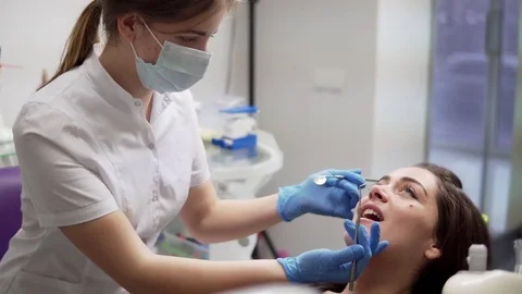Oral hygiene and dental care: Doctor dentist working with patient in dental Stock Footage