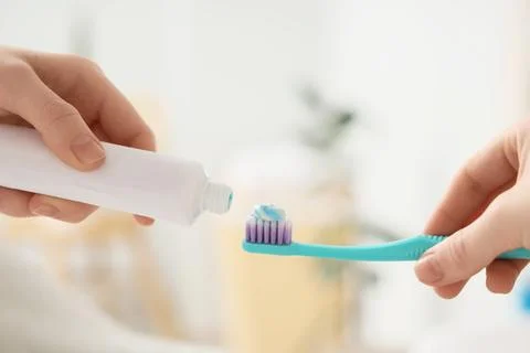 Oral hygiene routine with toothpaste squeezed onto a toothbrush for dental he Stock Photos