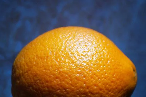 Orange on abstract blue background close up Stock Photos