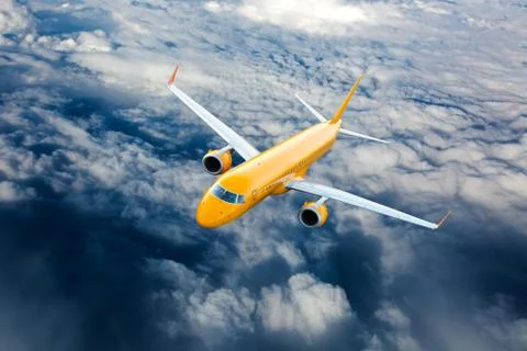 Orange airplane in flight. Stock Photos