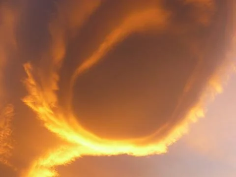 Orange alienlike Lenticular cloud, Altocumulus lenticularis Stock Photos