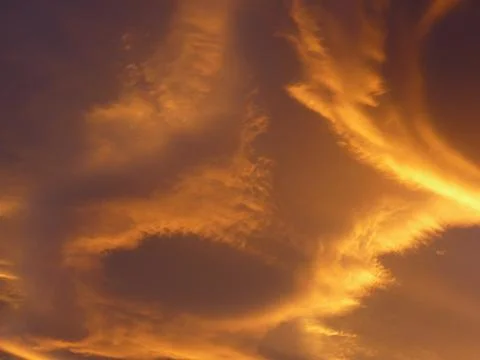 Orange alienlike Lenticular cloud, Altocumulus lenticularis Stock Photos