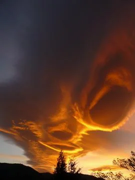 Orange alienlike Lenticular cloud, Altocumulus lenticularis Stock Photos