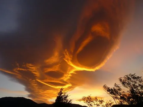 Orange alienlike Lenticular cloud, Altocumulus lenticularis Stock Photos