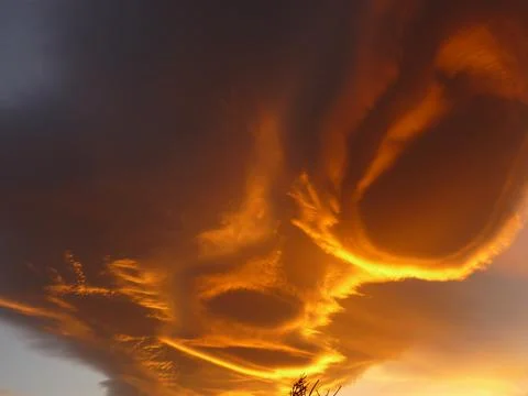Orange alienlike Lenticular cloud, Altocumulus lenticularis Stock Photos
