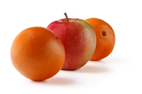 An orange and an Apple cut in half on a white background. Stock Photos