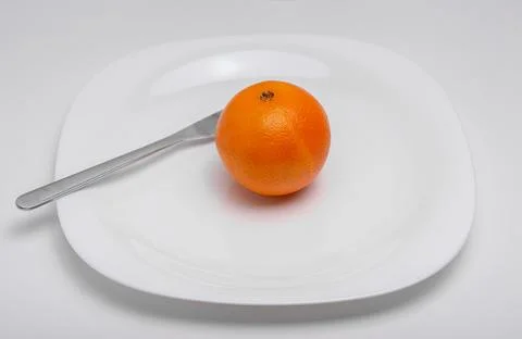 Orange and fork Stock Photos