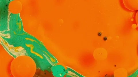 Orange and green sphere pops disappears vibrant bright paint and oil color Stock-Footage 81828766