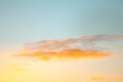 Orange and pink sunset clouds glowing across a blue winter sky above Senja,.. Stock Photos