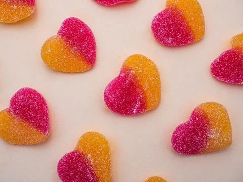 Orange and red candy hearts on a light background Stock Photos