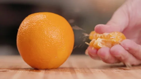 Orange and Squeezing a Slice with Juice on Side Video stock 155111196