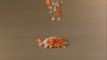 Orange and White Candy Falls on Wooden Table in Slow Motion 스톡 동영상 85533435