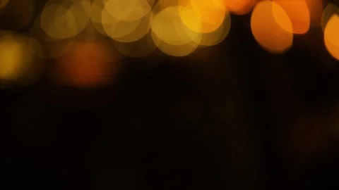 Orange and yellow circular highlights on a black background at the top of the fr Stock Footage 324854258