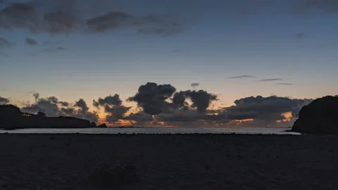 Orange and yellow sky sunset at a sandy ocean beach - timelapse Stock Footage 219767591