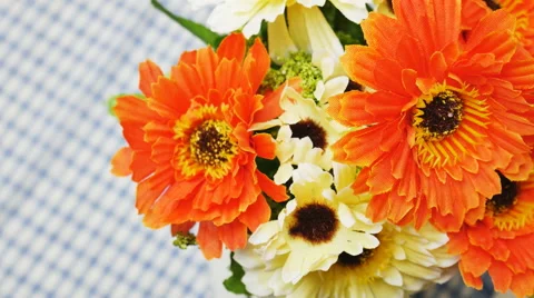 Orange artificial flowers on the dining table Stockbeeldmateriaal 57681863