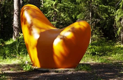 Orange artwork in the middle of the forest Stock Photos