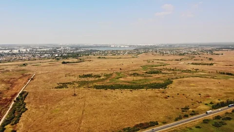 Orange autumn fields with roads and town in background Stock Footage 111474457