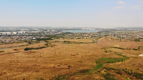 Orange autumn fields with town in background Stock Footage 111474255