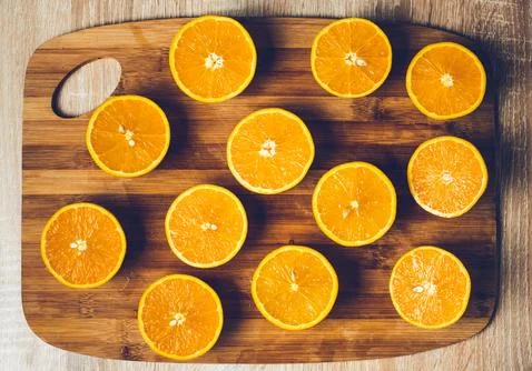 Orange background. Closeup of half cut fruits Stock Photos