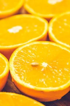 Orange background. Closeup of half cut fruits Stock Photos