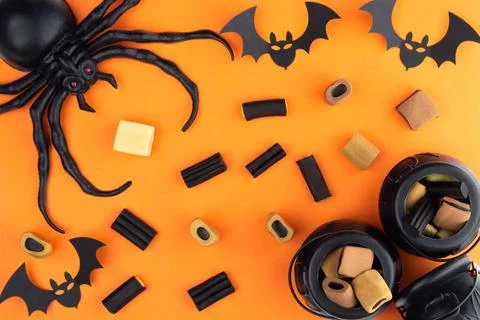 On an orange background, the composition to Halloween. A spider sits in the c Stock Photos