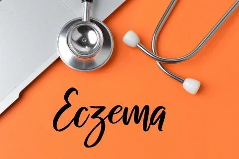 Orange background written with text ECZEMA. Health concept. Stock Photos