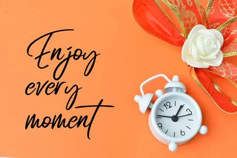 Orange background written with text ENJOY EVERY MOMENT. Stock Photos