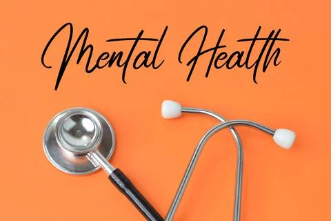 Orange background written with text MENTAL HEALTH. Stock Photos