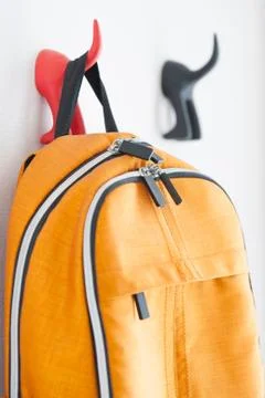 Orange backpack on the wall Stock Photos