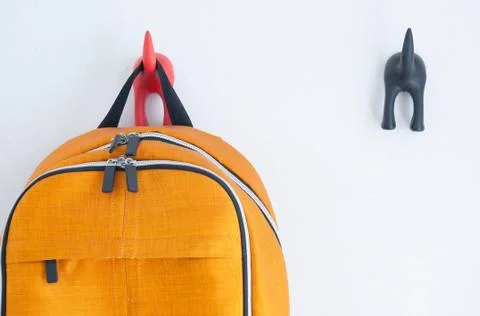 Orange backpack on the wall Stock Photos