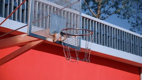 Orange ball fall in basket on sunny summer day. Concept of urban playing field. Stock-Footage 110618232