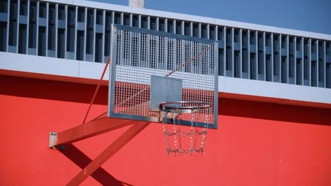 Orange ball fall through the hoop with metal chain net. Scoring winning points. Stock Footage 110618364