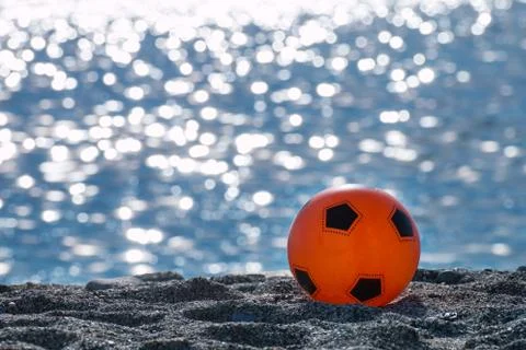 Orange ball isolate on the beach Stock Photos