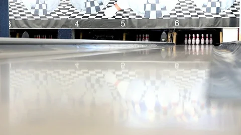 Orange ball knocks skittles in bowling Stock Footage 114137318