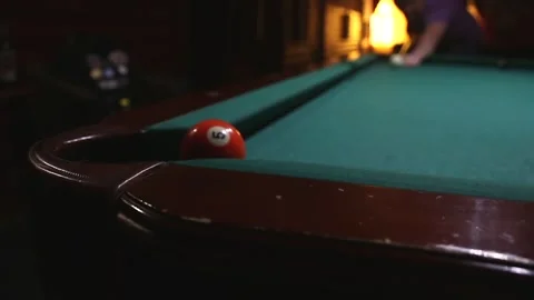 The orange ball at number 5 flew into the pocket of the pool table in the video Stock Footage 339029206