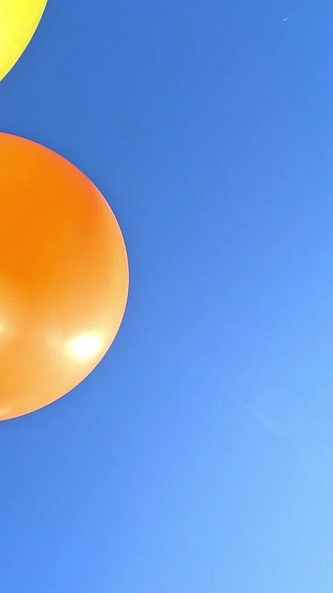 Orange Balloon Drifting Across Clear Blue Sky, Minimal Copy Space Video stock 325730267