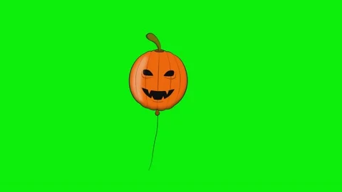 An orange balloon with a smiling face on it and halloween pumpkin flying Stock Footage 345497045