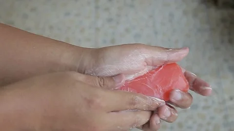 Orange bar soap held by a man's hand Stock Footage 254619181