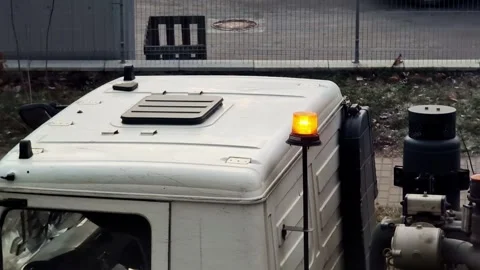 Orange beacon on a white cabin of a specialized cargo vehicle, close-up 스톡 동영상 304111306