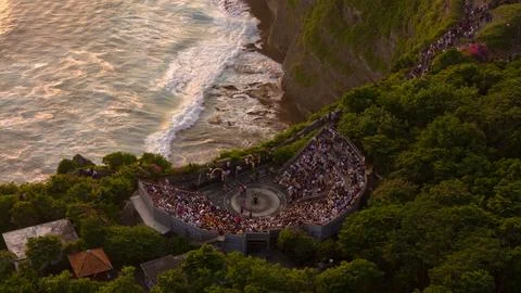 An orange beautiful sunset is reflected on the surface of the ocean and a theatr Stock Photos