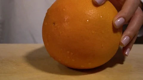 Orange being cut on chopping board Stock Footage 79473298