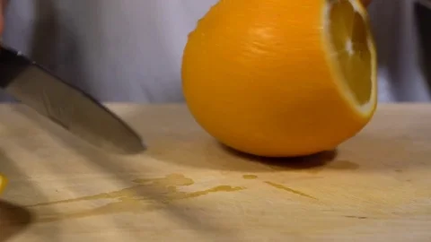 Orange being cut on chopping board Stock Footage 79473329