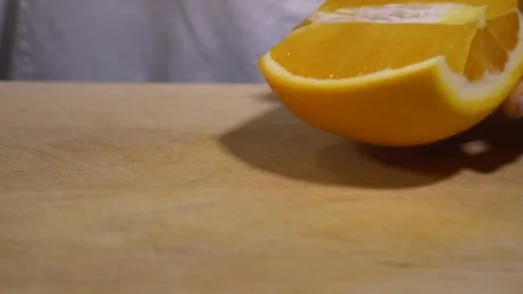 Orange being cut on chopping board Stock Footage 79473344