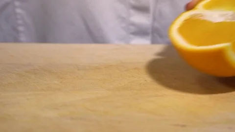 Orange being cut on chopping board Stock Footage 79473348