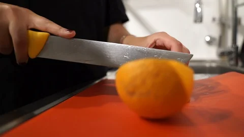 Orange Being Cut By Large Knife Vídeos de archivo 87454646