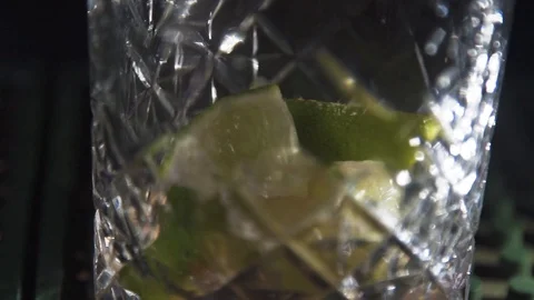 Orange bits being shuashed into glass Stock Footage 90123637